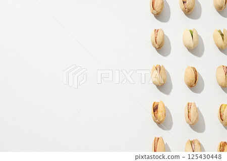 Pistachios in the shell, on a light background. 125430448