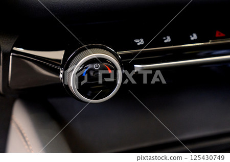 Climate control in a car. Temperature control buttons on a car air conditioner. Climate control in a car. Temperature control buttons on a car air conditioner. 125430749