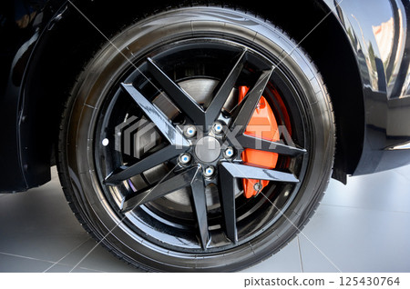 Car wheel with brake calipers and stylish design. 125430764