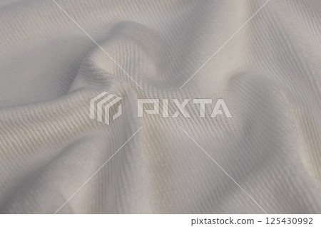 Crumpled material for the production of clothing and other items, white natural cotton yarn material closeup Crumpled material for the production of clothing and other items, white natural cotton yarn material closeup 125430992