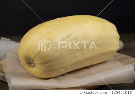 squash with a peel, ripe white squash on the kitchen table before cooking squash with a peel, ripe white squash on the kitchen table before cooking 125431018