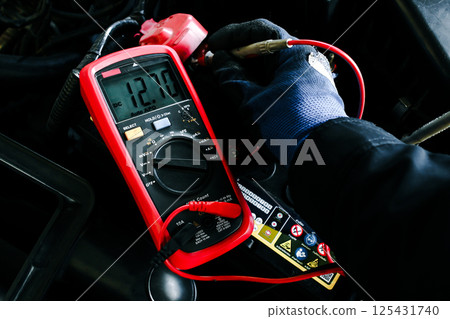 Car Battery Voltage Test displaying a reading of 12.70V DC Car Battery Voltage Test displaying a reading of 12.70V DC 125431740