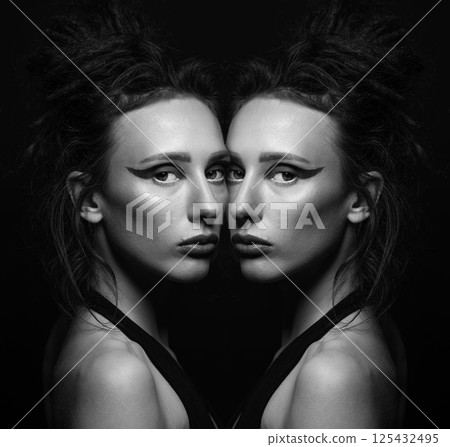 Abstract studio portrait of beautiful woman with eye shadows and dreadlocks in reflection effect 125432495