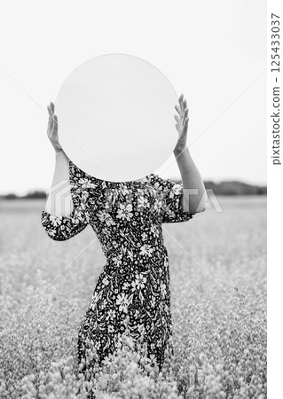 Mystery Woman Portrait with Round Mirror in the Wheat Field 125433037
