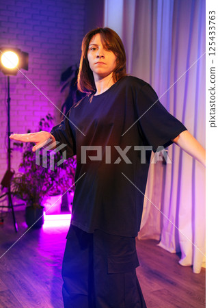 Dance performance in a modern studio with colorful lighting during an evening rehearsal Dance performance in a modern studio with colorful lighting during an evening rehearsal 125433763
