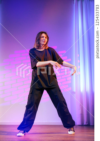 Dance performance showcasing contemporary style with vibrant lighting and expressive movement 125433783