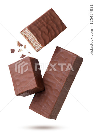 Wafer in chocolate and two halves with crumbs flying on a white background. Isolated 125434051