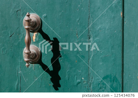 Vintage Door Handle with Strong Shadow 125434076