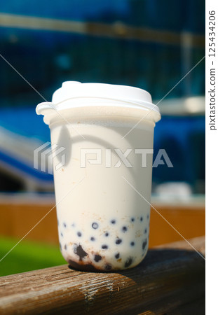 Milk bubble tea in plastic cup with blurred background 125434206