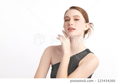A beautiful young woman with clean, fresh skin against a white background. Skincare, facial treatment, cosmetology, beauty, and spa. An elegant portrait of an woman. A beautiful young woman with clean, fresh skin against a white background. Skincare, facial treatment, cosmetology, beauty, and spa. An elegant portrait of an woman. 125434260