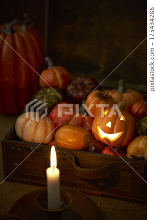 Pumpkins stuffed into an old trunk - Halloween image Pumpkins stuffed into an old trunk - Halloween image 125434288