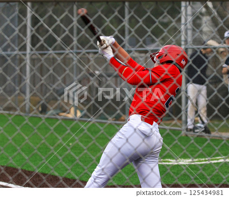 Baseball player swinging at the ball during a game Baseball player swinging at the ball during a game 125434981