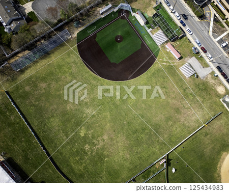 Drone View Above a Baseball Field With New Brown and Green Turf and Empty Bleachers 125434983