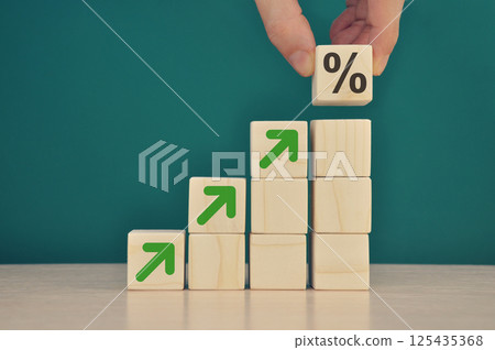 Businessman stacking wooden blocks into growing char 125435368
