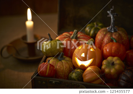 Pumpkins stuffed into an old trunk - Halloween image 125435577