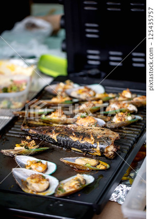 Grilled Seafood Feast on Hot Griddle 125435757