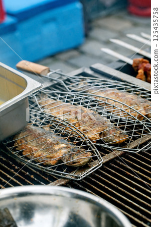 Fish Grilling on Metal Mesh Basket 125435758