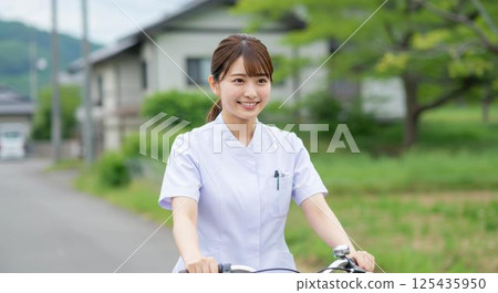 A young local nurse makes bicycle tours around rural areas 125435950
