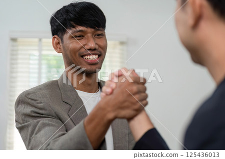 Business Meeting and Collaboration. Two professionals engaging in a handshake to signify partnership. Business Meeting and Collaboration. Two professionals engaging in a handshake to signify partnership. 125436013
