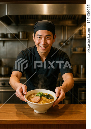 Smiling chef serving ramen over the counter Smiling chef serving ramen over the counter 125436065