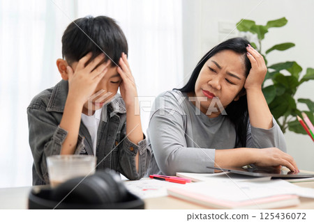 Challenges and Support. A mother comforts her son who is feeling frustrated while studying at home. Challenges and Support. A mother comforts her son who is feeling frustrated while studying at home. 125436072