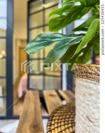 Balcony relax area with garden furniture, green flower, boho style 125436453