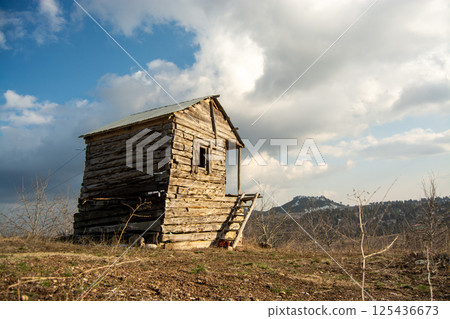 Abandoned wooden house with cloudy sky 125436673
