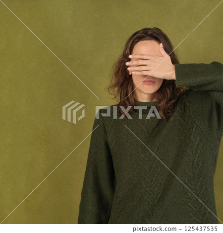 Woman Covering Her Eyes With Hand 125437535