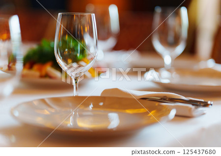 An empty wine glass on a table served for a banquet. An empty wine glass on a table served for a banquet. 125437680