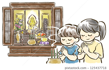 Children light incense and join hands in prayer in front of the Buddhist altar. 125437718
