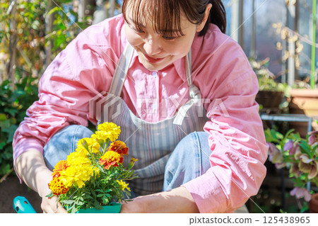 Woman planting flowers Gardening 125438965