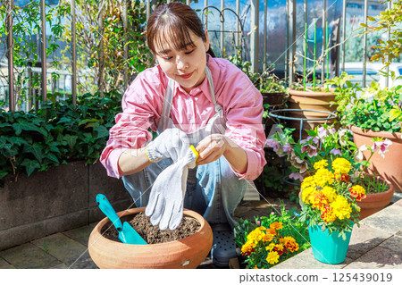 Woman planting flowers Gardening 125439019