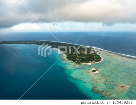 Aerial view of Rangiroa atoll, French Polynesia, with lagoon and cloudy sky 125439282