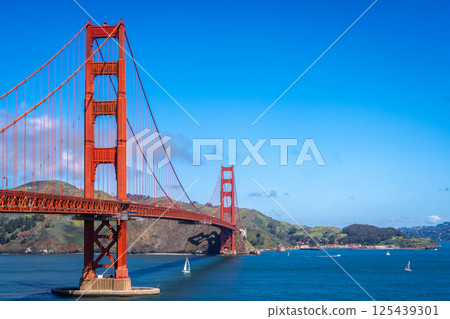 Golden Gate Bridge over blue waters with scenic hills in San Francisco 125439301