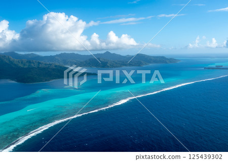Aerial view of Tahaa island, French Polynesia, with turquoise lagoon and reef Aerial view of Tahaa island, French Polynesia, with turquoise lagoon and reef 125439302