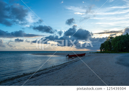 Serene sunset on a tropical beach in Tikehau, French Polynesia Serene sunset on a tropical beach in Tikehau, French Polynesia 125439304