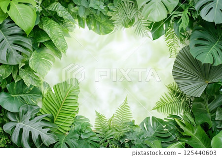 Lush greenery with tropical leaves forming natural frame and copy space. Lush greenery with tropical leaves forming natural frame and copy space. 125440603