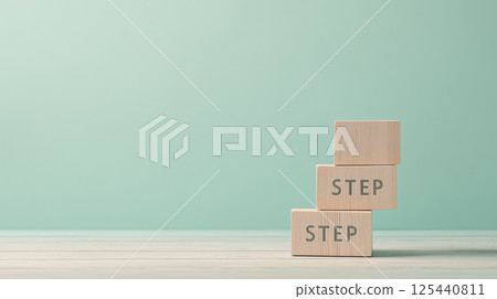 A stepped wooden cube represents a new stage | Mint green space 125440811