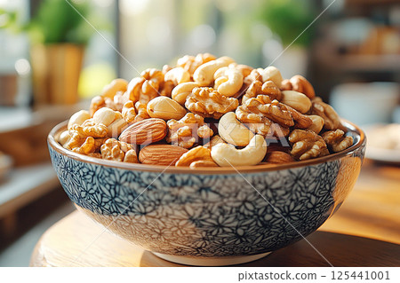 Healthy mix of almonds, walnuts and cashews in a bowl. Healthy mix of almonds, walnuts and cashews in a bowl. 125441001