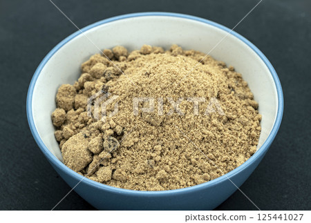 Organic Brown Sugar Bowl: A close-up of a brightly colored brown sugar bowl filled with organic coarse brown sugar. Organic Brown Sugar Bowl: A close-up of a brightly colored brown sugar bowl filled with organic coarse brown sugar. 125441027
