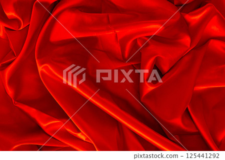 Red silk or satin luxury fabric texture can use as abstract background. Top view. Red silk or satin luxury fabric texture can use as abstract background. Top view. 125441292