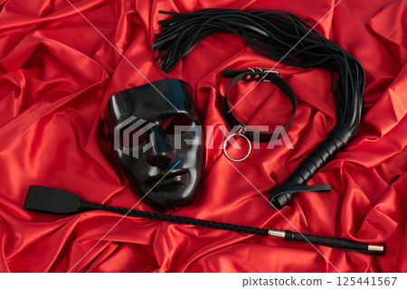 Adult sex games. Kinky lifestyle. Spank on the red linen. Bdsm outfit 125441567