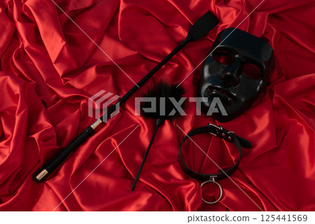 Adult sex games. Kinky lifestyle. Spank on the red linen. Bdsm outfit 125441569