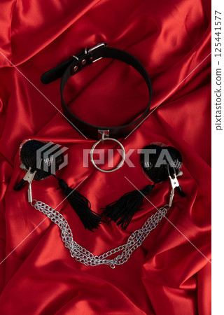 Adult sex games. Kinky lifestyle. Spank on the red linen. Bdsm outfit 125441577
