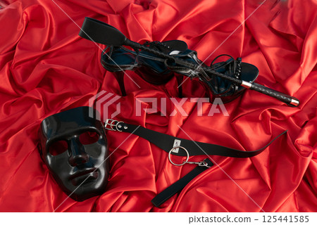 Adult sex games. Kinky lifestyle. Spank on the red linen. Bdsm outfit 125441585
