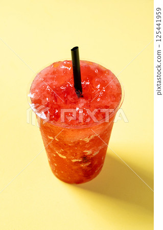 Red strawberry slushieon yellow background Red strawberry slushieon yellow background 125441959