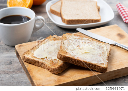 Sliced fresh bread and butter on wooden table Sliced fresh bread and butter on wooden table 125441971