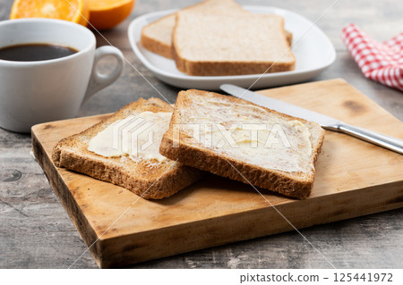 Sliced fresh bread and butter on wooden table Sliced fresh bread and butter on wooden table 125441972