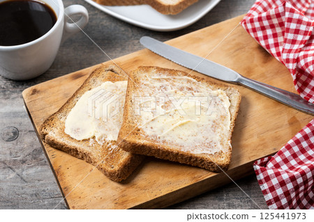 Sliced fresh bread and butter on wooden table Sliced fresh bread and butter on wooden table 125441973