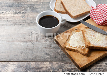 Sliced fresh bread and butter on wooden table Sliced fresh bread and butter on wooden table 125441974